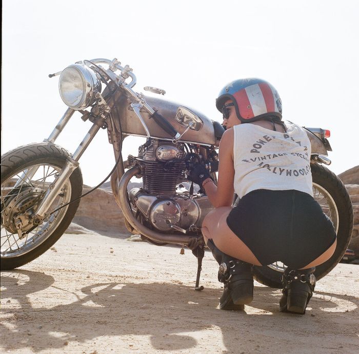 A playful frame from Girls on a motorcycle — online in Denver